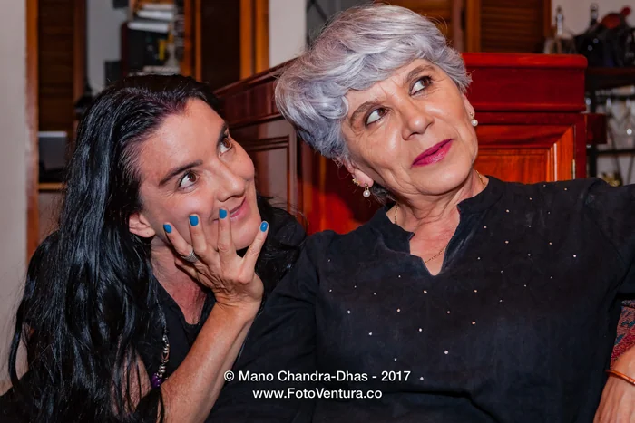 A Senior Silver Haired Latin Lady And Her Niece Listening Intently To The Story