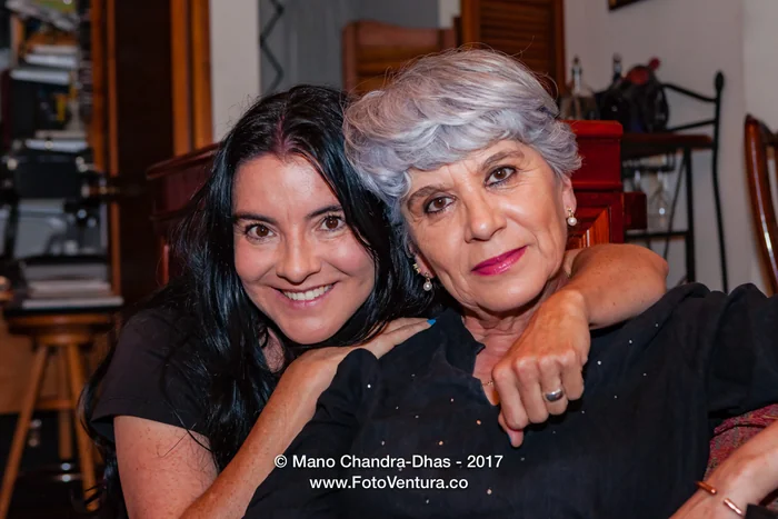 A Senior Hispanic Silver Haired Lady Is Given A Hug By Her Niece
