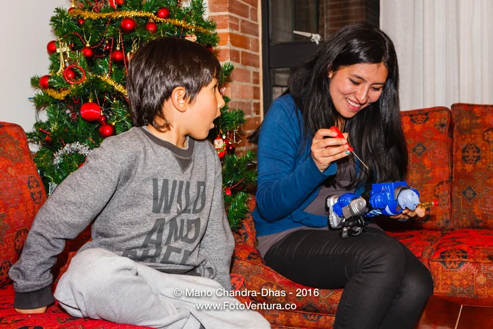 Bogota, Colombia - Mother helps son with new toy
