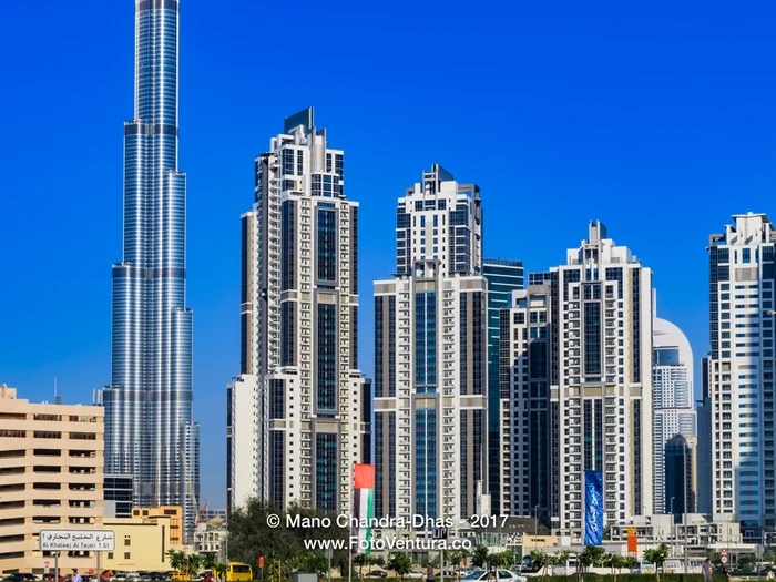Dubai, UAE: Skyline In Bright Afternoon Sunlight Against A Bright Blue Sky