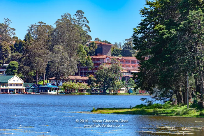 Kodaikanal, South India - Looking Across Kodaikanal Lake Towards The Boathouse and the Carlton Hotel, On The Palni Hills, In The Colonial Town In The State Of Tamil Nadu, In The Morning Sunlight; Copy Space.