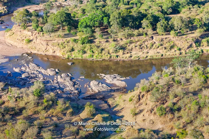Kenya, East Africa - The Mara River In the Dry Season And SOme Hippopotami In The Water - Aerial Shot From Hot Air Balloon