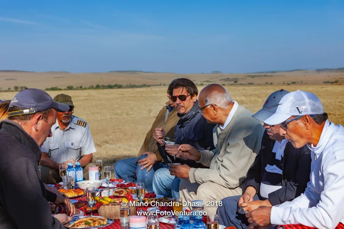 Kenya, East Africa - Tourists Enjoying A Champagne Breakfast On the Masai Mara National Reserve After An Early Morning Hot Air Balloon Safari