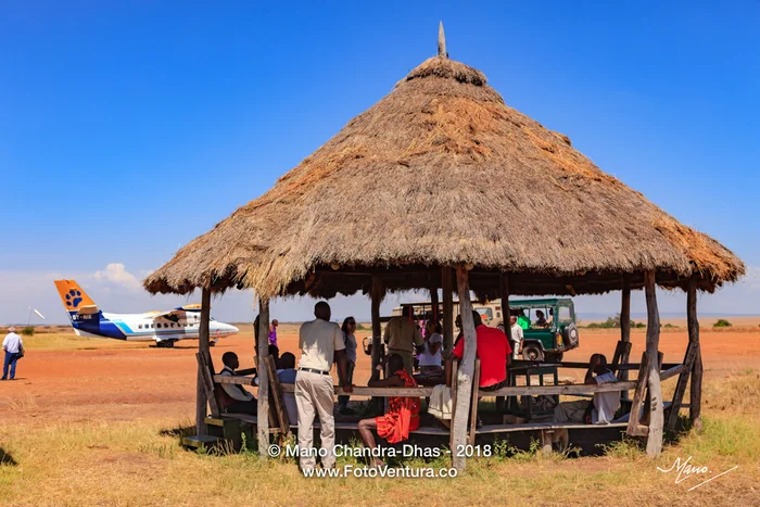 Kenya, East Africa - Passenger Facilities And Boarding In Progress At The Olkiombo Airstrip On The Masai Mara In The Great Rift Valley
