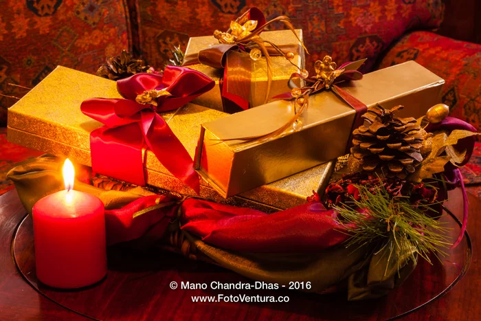 Christmas - gifts, gold boxes, ribbons, pine cone and candle.
