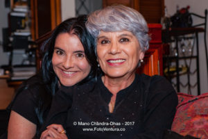 A Senior Hispanic Silver Haired Lady Is Given A Hug By Her Niece