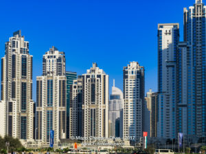 Dubai, UAE: Skyline In Bright Afternoon Sunlight Against A Bright Blue Sky