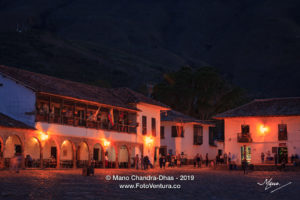 Colombia, South America - Tourists And Some Local Residents At Twilight Time, On The Eastern Corner Of The Main Square In The Historic 16th Century Town of Villa de Leyva In The Boyacá Department