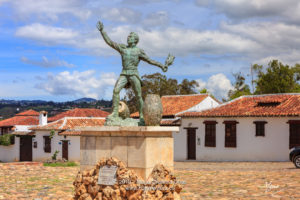 Colombia, South America - The Parque Ricaurte in the Historic 16th Century Andean Town Of Villa de Leyva, With The Statue Of The Martyr In The Centre Of the Square, In The Morning Sunlight