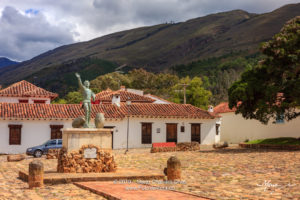 Colombia, South America - The Parque Ricaurte in the Historic 16th Century Andean Town Of Villa de Leyva, With The Statue Of The Martyr In The Centre Of the Square, In The Morning Sunlight