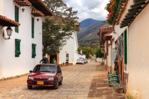 Colombia, South America - Looking At The Cobblestoned Carrera 10 In The Historic 16th Century Town Of Villa de Leyva, Boyacá Department; Background: Andes Mountains