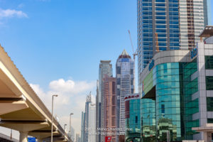 Dubai, United Arab Emirates - A Low Angle View Of Buildings On Sheikh Zayed Road; To The Left Are The Elevated Metro Tracks
