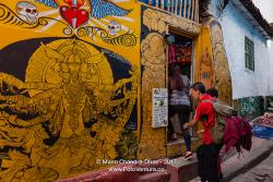 Bogotá, Colombia - Tourists On The Narrow, Colourful Calle Del Embudo