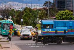 Bogotá Colombia - Railroad Crossing While a Railway Engine Moves Across the Road While Traffic Waits